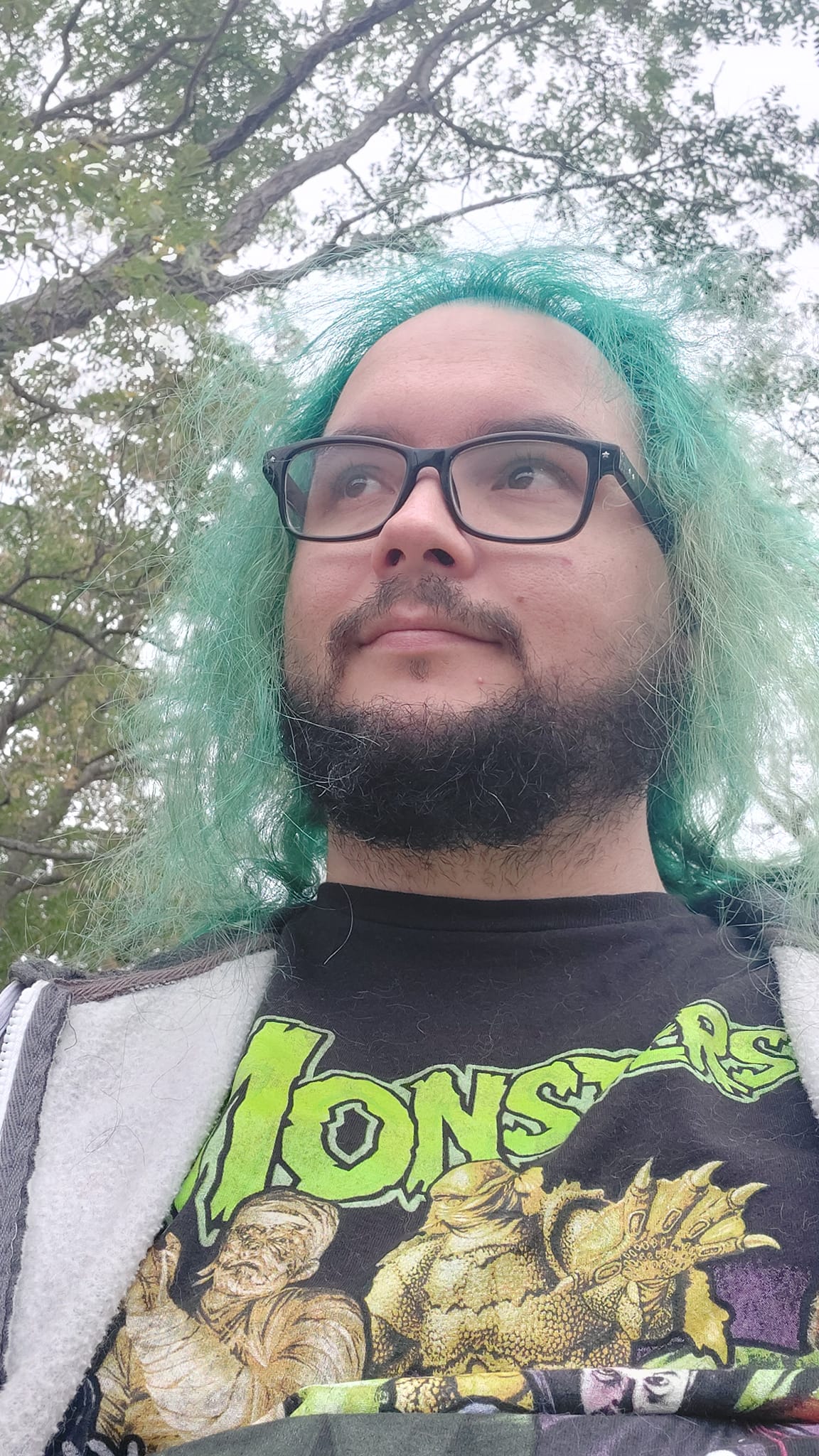 A man with green hair stands outside, photo 4